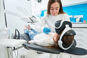 Patient with VR headset laying on dental chair